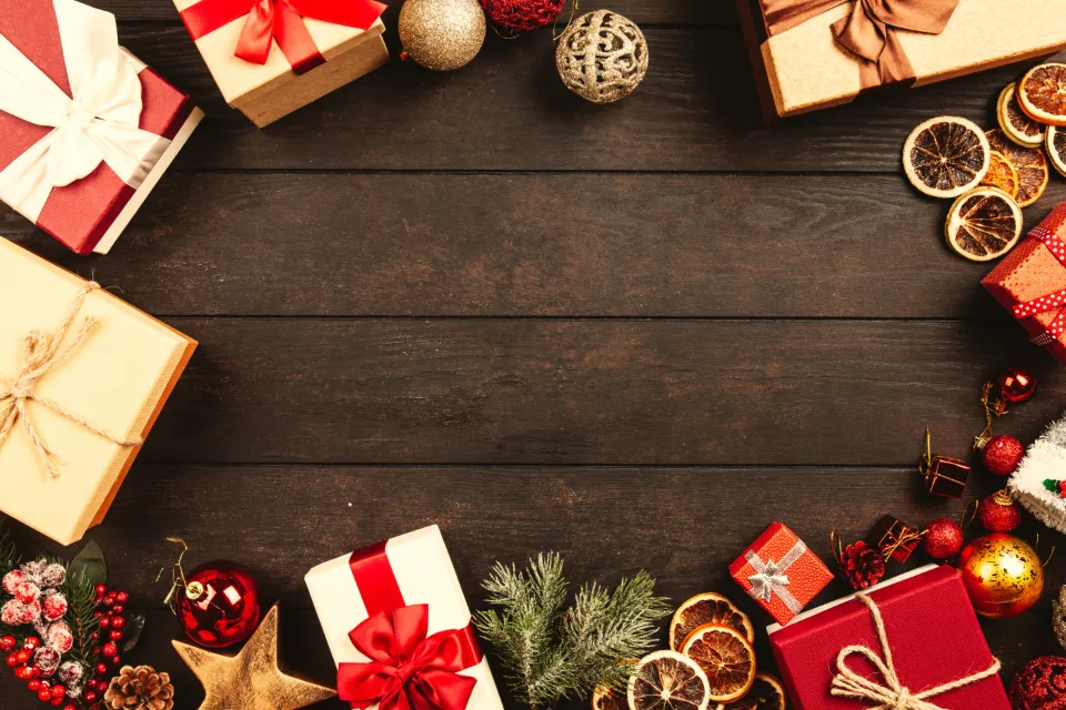 Wrapped holiday gift boxes on a wooden table, ideas for gifts for nail techs