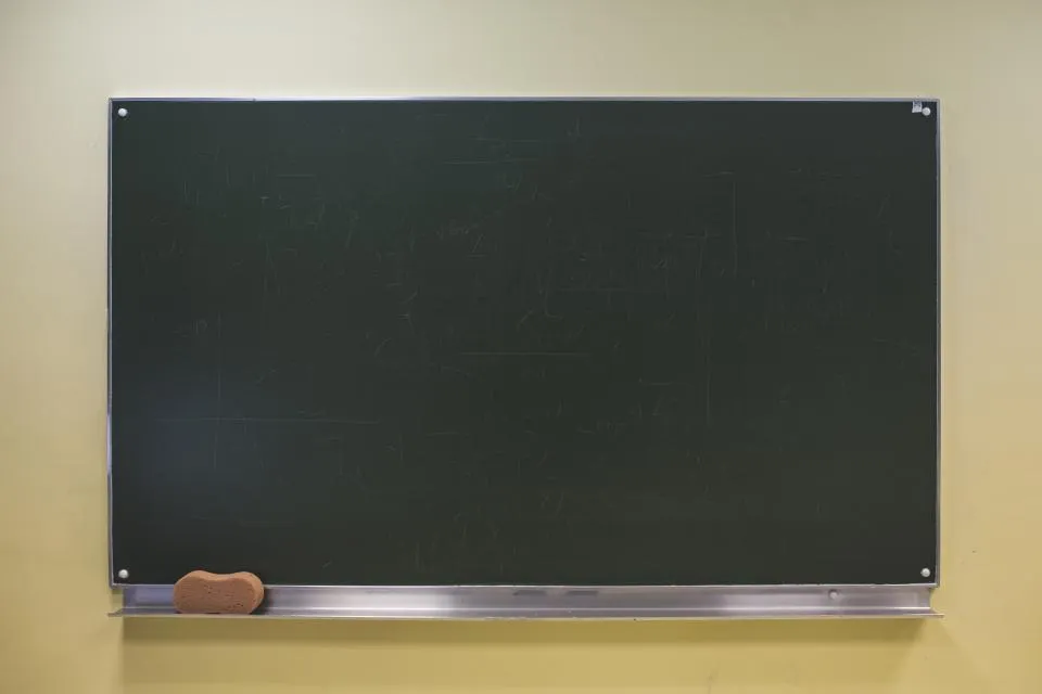 Blank chalkboard on a wall, ready to plan a new nail salon service menu